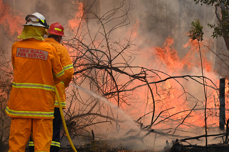 Firefighters tackle a bushfire to save a home in Taree, 350km north of Sydney on November 9, 2019 as they try to contain dozens of out-of-control blazes that are raging in the state of New South Wales. PHOTO: AFP