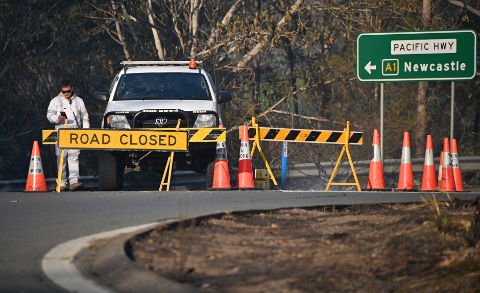 Roads are closed as a bushfire still smoulder in Old Bar, 350km north of Sydney on November 10, 2019. PHOTO: AFP