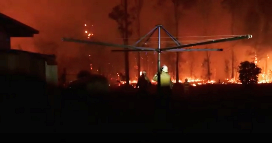 Firefighters look as a fire rages on in Rainbow Flat, New South Wales, Australia, November 8, 2019, in this still image taken from social media video. PHOTO: REUTERS