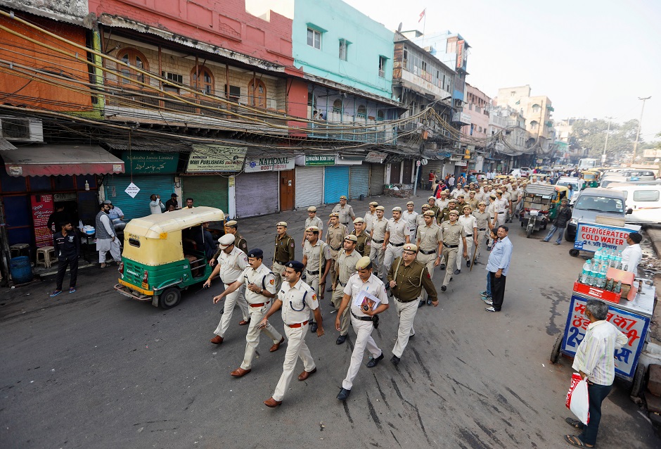 Police officersâ conduct a flag march on a street outside Jama Masjid, before Supreme Court's verdict on a disputed religious site claimed by both majority Hindus and Muslim in Ayodhya. PHOTO: Reuters