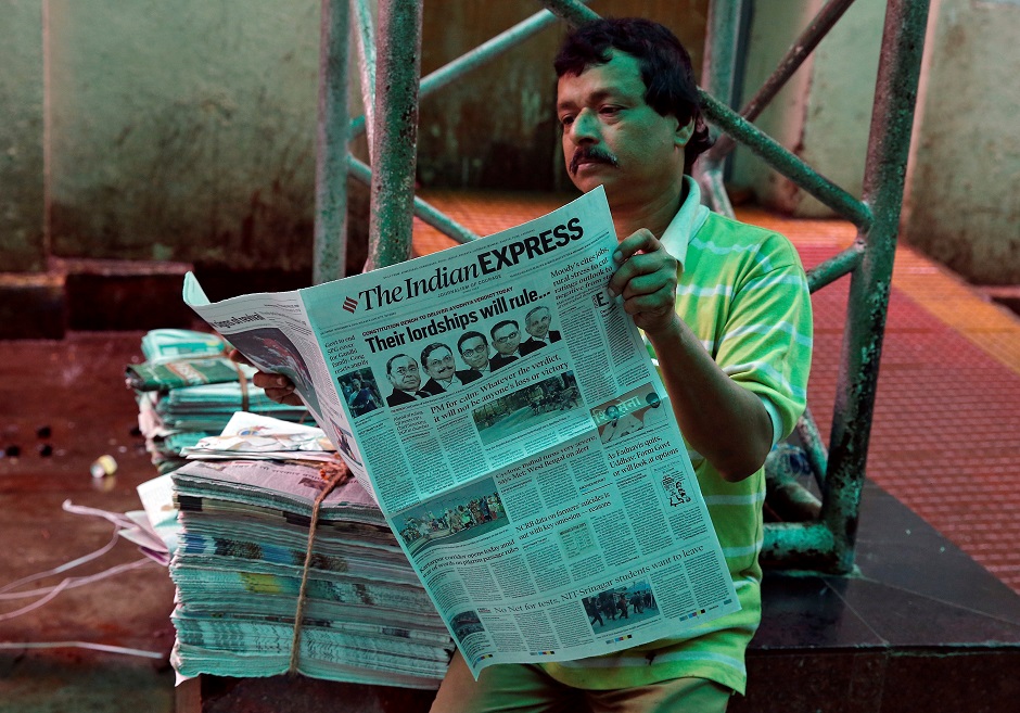 A man reads a newspaper with a headline about Supreme Court's verdict. PHOTO: Reuters