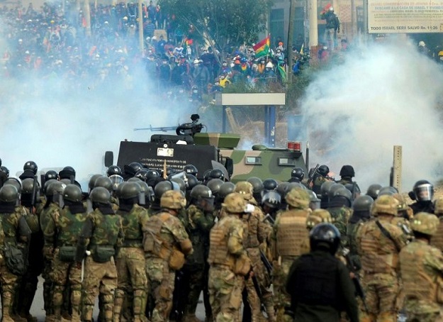 Bolivian riot police and soldiers clash with supporters of Bolivia's ex-President Evo Morales during a protest against the interim government in Sacaba, Chapare province, Cochabamba department on November 15, 2019. PHOTO: AFP