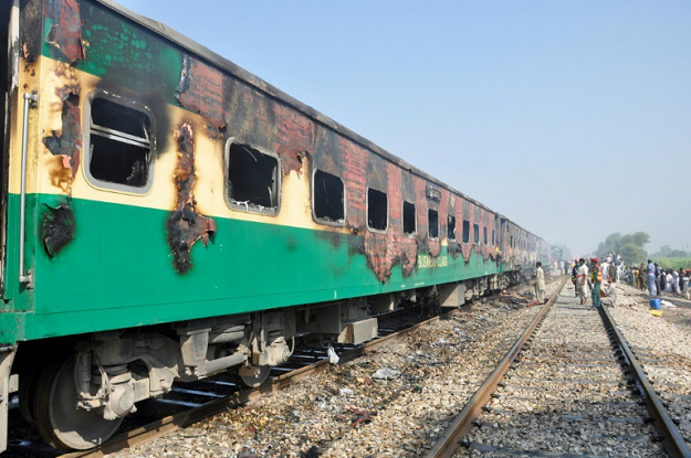 A fire, sparked by an exploding gass cylinder, tore through the packed train, killing dozens of people, many of them pilgrims travelling to a religious festival. PHOTO: AFP
