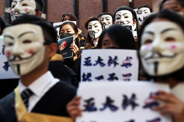University students wearing Guy Fawkes masks pose during a news conference to support anti-government protests before their graduation ceremony at the Hong Kong Polytechnic University in Hong Kong. PHOTO: Reuters