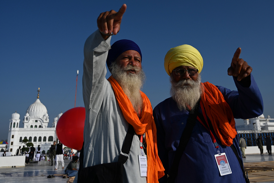 Sikh pilgrims point at the inauguration site of the Shrine of Baba Guru Nanak Dev at Gurdwara Darbar Sahib in Kartarpur, on November 9, 2019. PHOTO: AFP