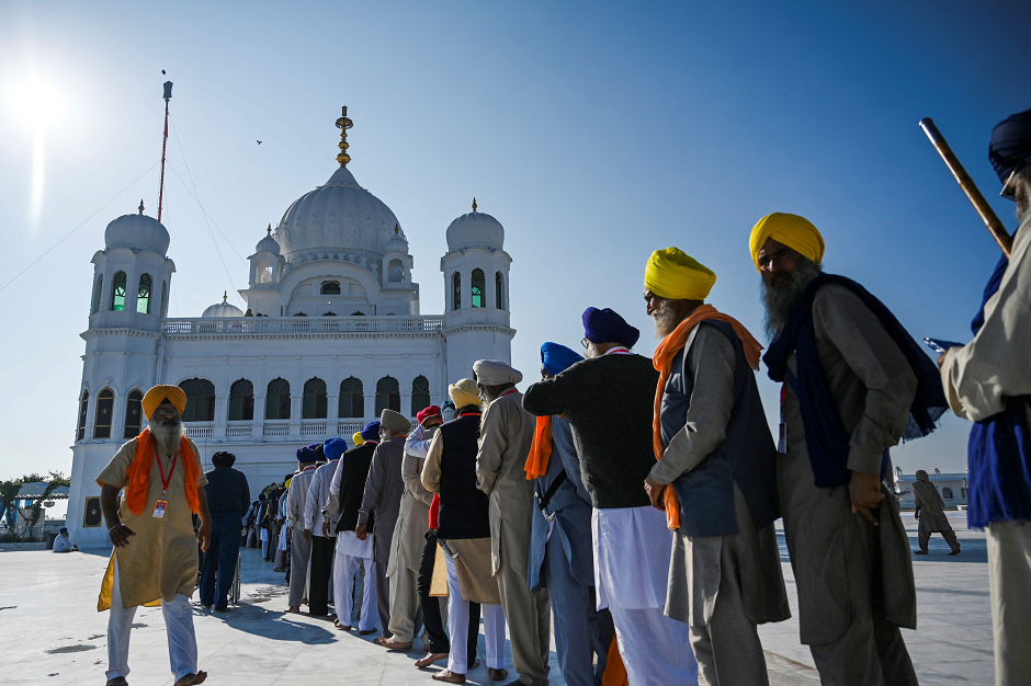 Sikh Pilgrims stand in a queue to visit the Shrine of Baba Guru Nanak Dev at Gurdwara Darbar Sahib in Kartarpur, on November 9, 2019. PHOTO: AFP
