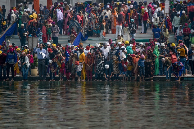 Sikh devotees pay their respects on the occasion of the 550th birth anniversary of Sikhism founder. PHOTO: AFP