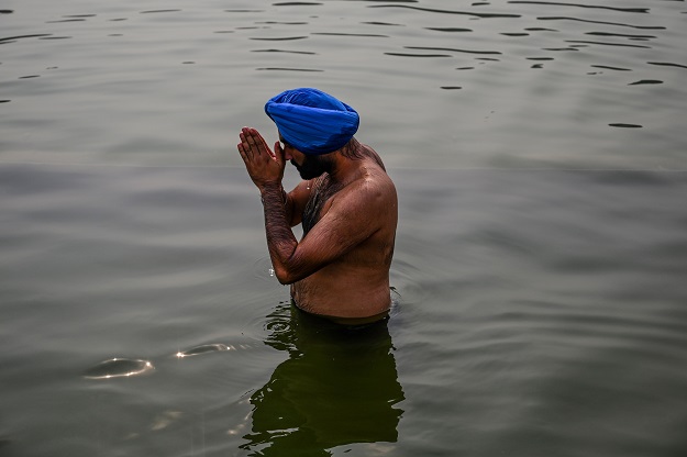 A Sikh devotee takes a holy dip on the occasion. PHOTO: AFP