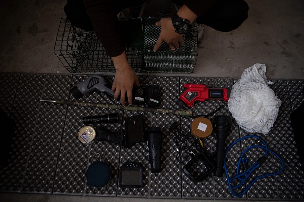This photo shows pet detective Sun Jinrong sitting next to his equipment as he prepares to search for a missing cat in a residential compound in Beijing. PHOTO: AFP