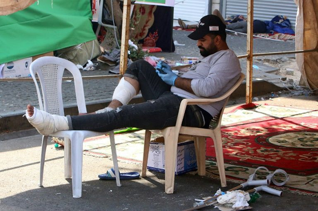 A wounded Iraqi protester rests under a tent in Al-Khalani square of central Baghdad. PHOTO: AFP