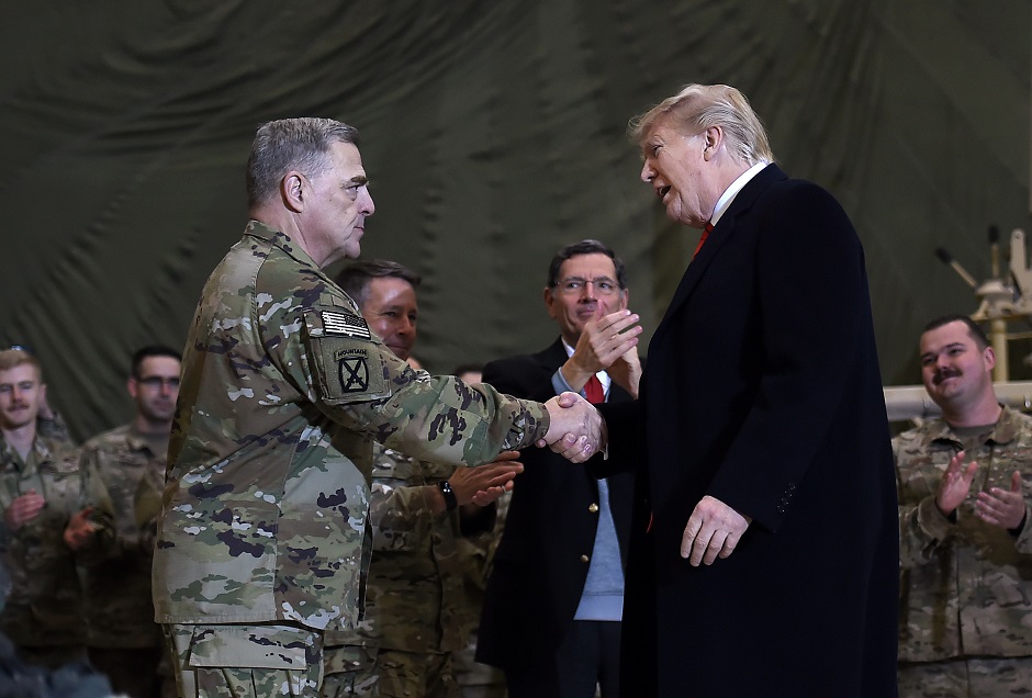 US President Donald Trump shakes hands with Joint Chiefs Chairman General Mark Milley after addressing the troops at Bagram Air Field during a surprise Thanksgiving day visit. PHOTO: AFP