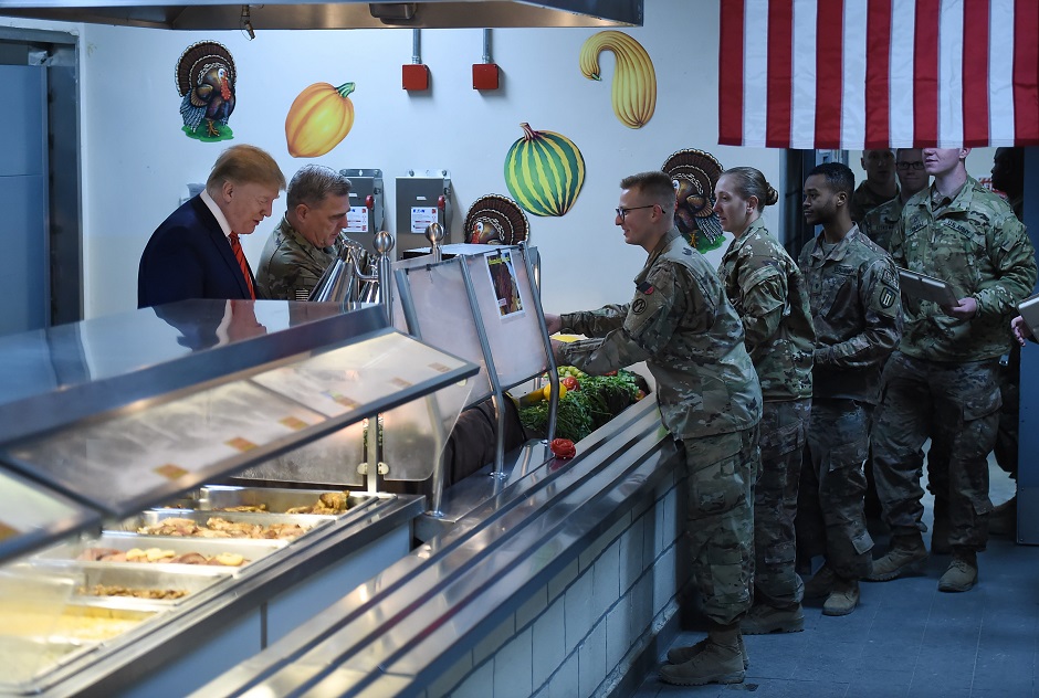 US President Donald Trump serves Thanksgiving dinner to US troops at Bagram Air Field. PHOTO: AFP