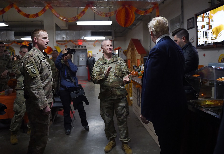 US President Donald Trump is greeted by military personnel at a Thanksgiving dinner. PHOTO: AFP