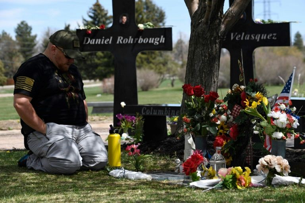 A man visits the memorial for victims of the 1999 Columbine High School shooting at the Chapel Hill Memorial Gardens in Littleton, Colorado in April 2019. PHOTO: AFP