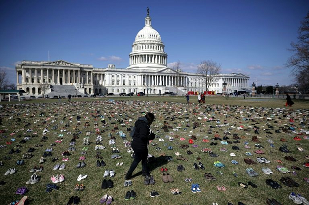 Activists spread 7,000 pairs of shoes, representing the children killed by gun violence since the mass shooting at Sandy Hook Elementary School in 2012, on the lawn on the east side of the US Capitol in March 2018. PHOTO: AFP