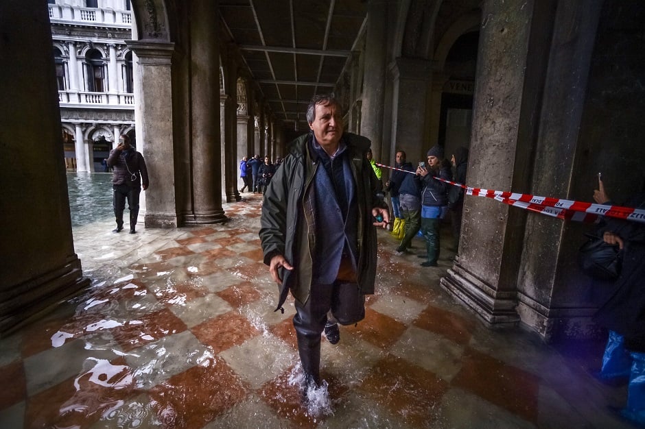 Venice mayor Luigi Brugnaro walks through a flooded arcade by St. Mark's Square. PHOTO: AFP