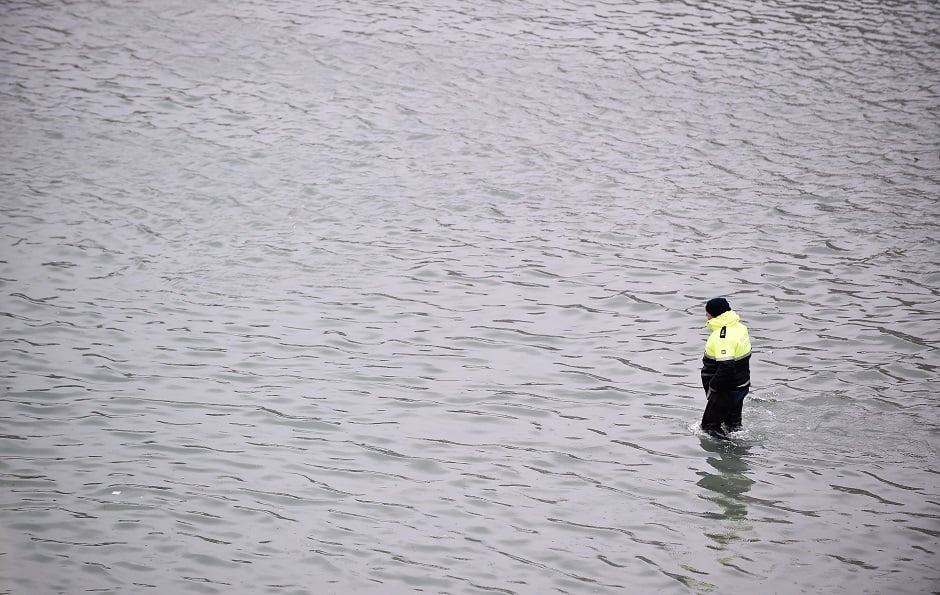 A police officer wades at the flooded St. Mark's Square, as high tide reaches peak. PHOTO: Reuters