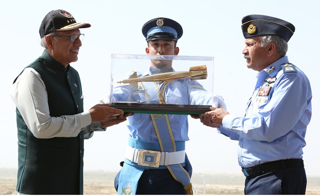 Air Chief Marshal Mujahid Anwar Khan, Chief of the air staff, Pakistan Air Force presenting a souvenir to President Dr Arif Alvi during the event. PHOTO: PAF