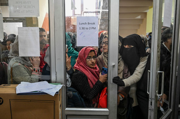 In this photo taken on November 26, 2019, Kashmiri students wait for their turn to use the internet at the Divisional Commissioner's office in Srinagar, as internet facilities have been suspended across the region as part of a partial communication blockade by the Indian government. PHOTO: AFP