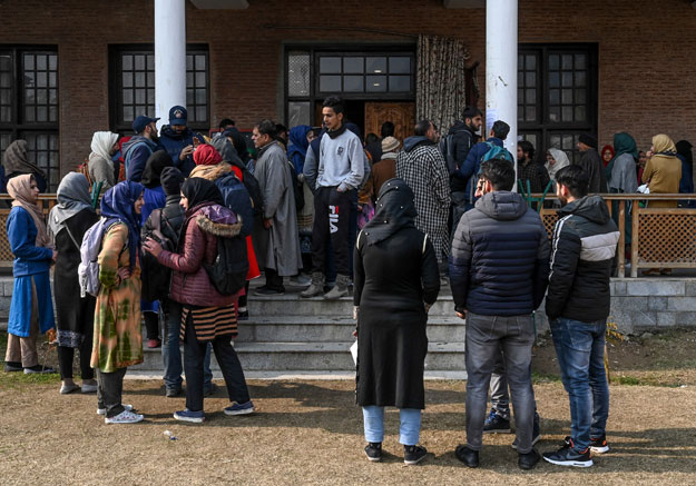 In this photo taken on November 26, 2019, Kashmiri students wait for their turn to use the internet at the Divisional Commissioner's office in Srinagar, as internet facilities have been suspended across the region as part of a partial communication blockade by the Indian government. PHOTO: AFP