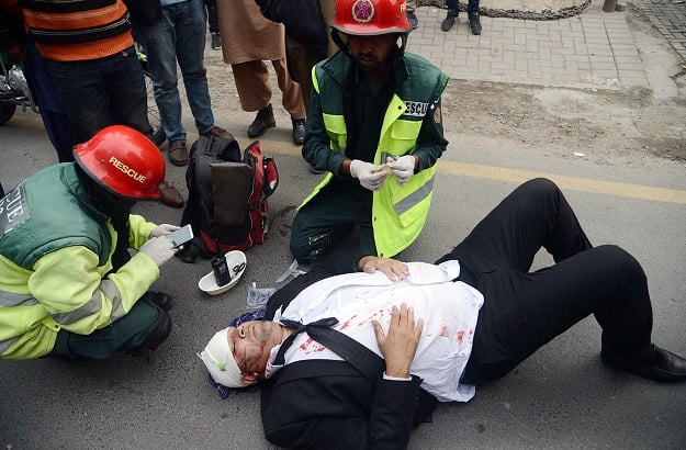 Rescue workers giving first-aid to an injured lawyer after a clash between doctors and lawyers at PIC. PHOTO: ONLINE