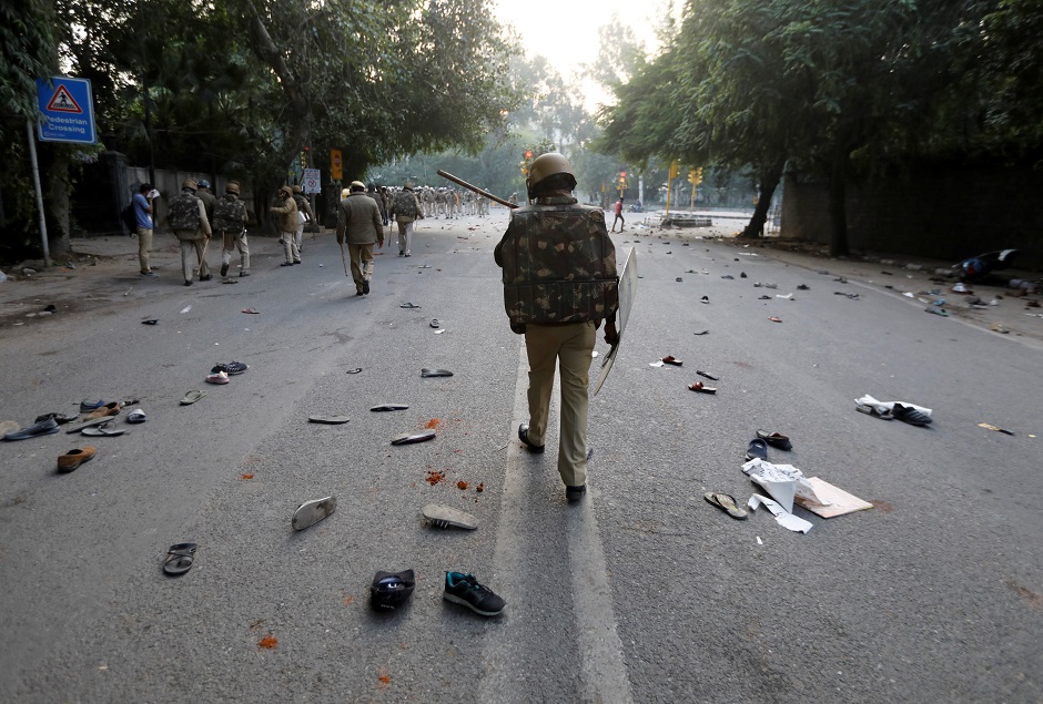 The shoes of demonstrators are seen scattered along the road as police patrol after a protest against a new citizenship law, in New Delhi. PHOTO: REUTERS 