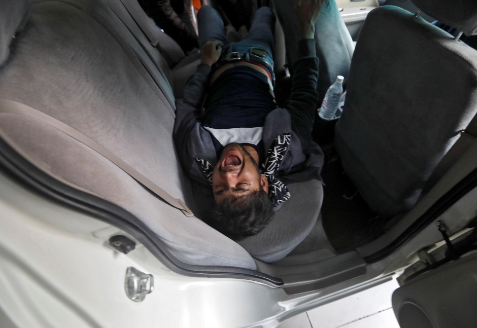 A man grimaces in pain after he was injured during a protest against a new citizenship law, in New Delhi. PHOTO: REUTERS 