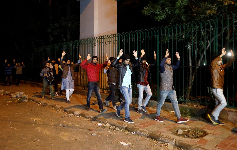 Students raising their hands leave the Jamia Milia University following a protest against a new citizenship law. PHOTO: REUTERS 