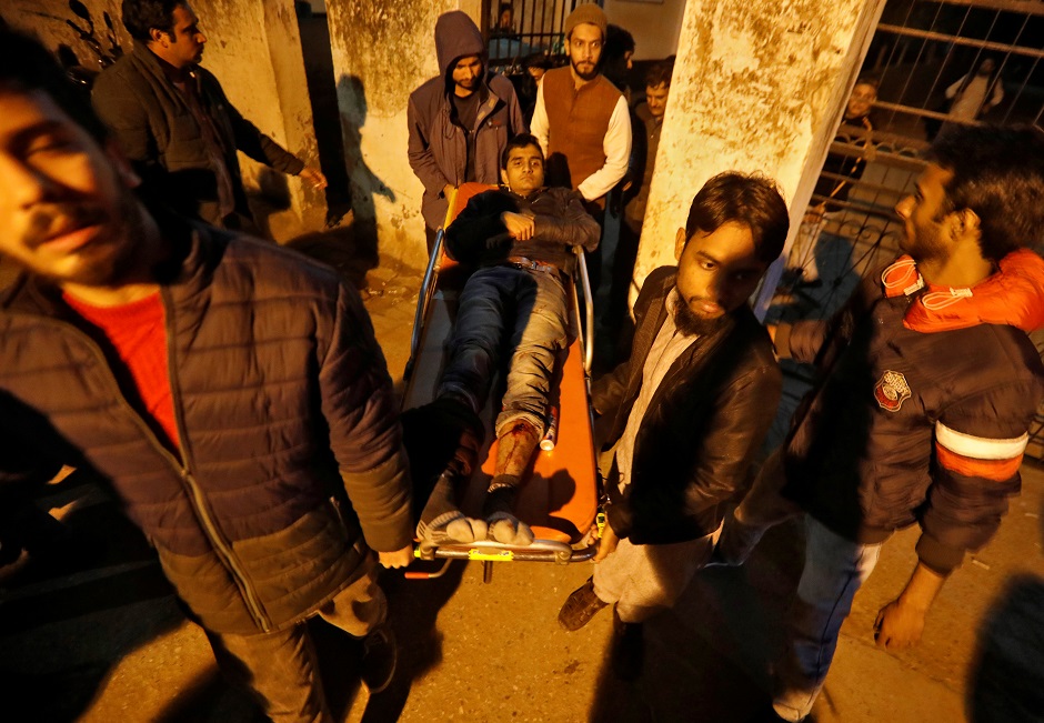 An injured man is shifted to a hospital after he was wounded during a protest against a new citizenship law, in New Delhi. PHOTO: REUTERS 