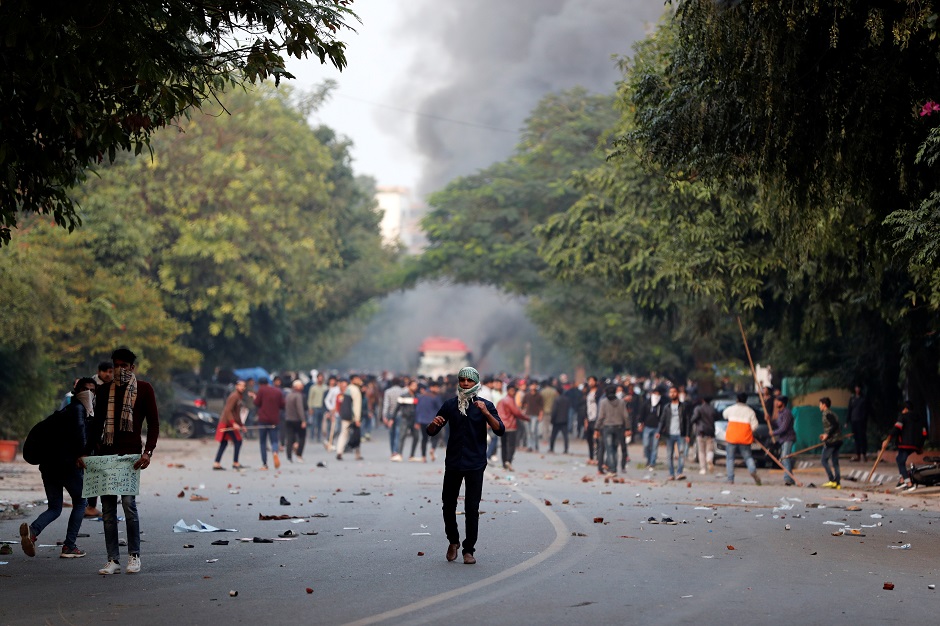Demonstrators hurl stones towards police during protest. PHOTO: REUTERS 