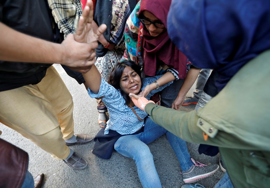 A woman reacts after she was injured during a protest against a new citizenship law, in New Delhi. PHOTO: REUTERS 