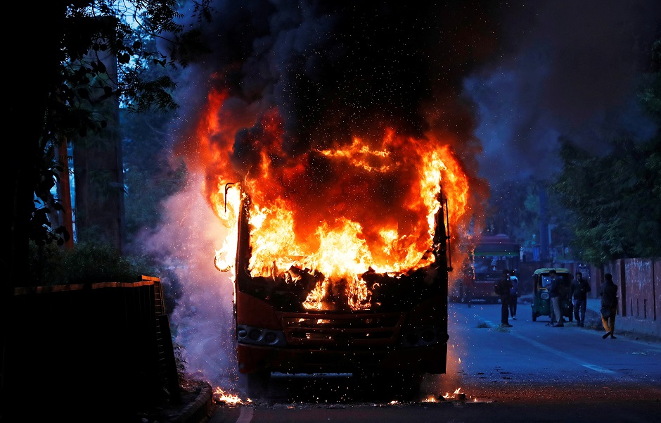  A passenger bus burns after it was set on fire by demonstrators. PHOTO: REUTERS 