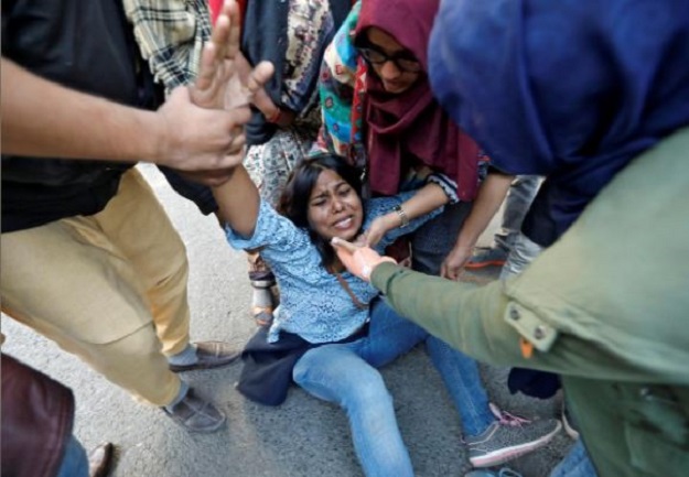 A woman reacts after she was injured during a protest against a new citizenship law, in New Delhi. PHOTO: REUTERS