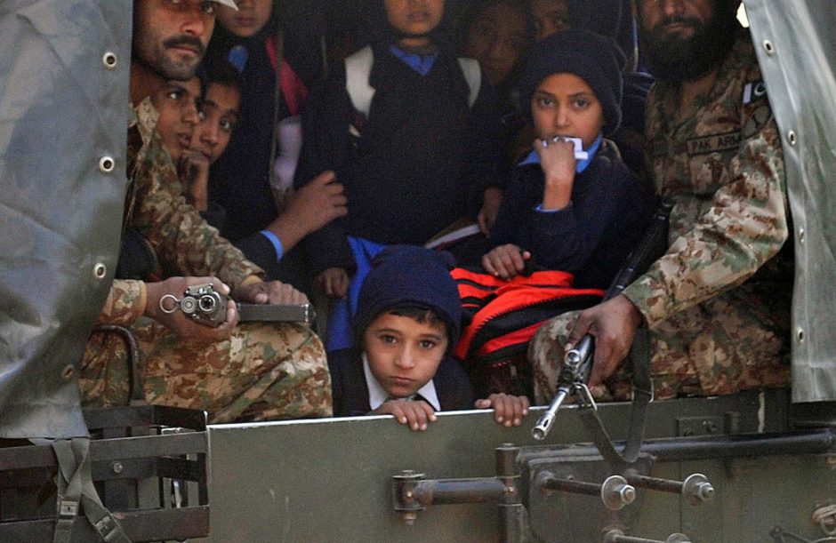 Pakistani soldiers transport rescued school children from the site of an attack by Taliban gunmen on a school in Peshawar on December 16, 2014. Taliban insurgents killed at least 130 people, most of them children, after storming an army-run school in Pakistan December 16 in one of the country's bloodiest attacks in recent years. PHOTO: AFP