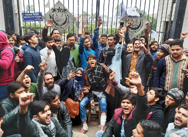 Demonstrators shout slogans during a protest outside a gate of the Jamia Millia Islamia university in New Delhi. PHOTO: Reuters