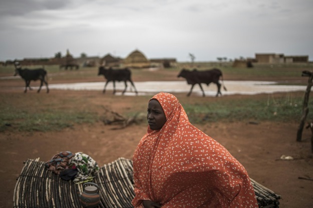 The long trail: Safira, a nomadic herder, sits on a straw mat outside her family hut in a Fulani camp in Dosso. PHOTO: AFP
