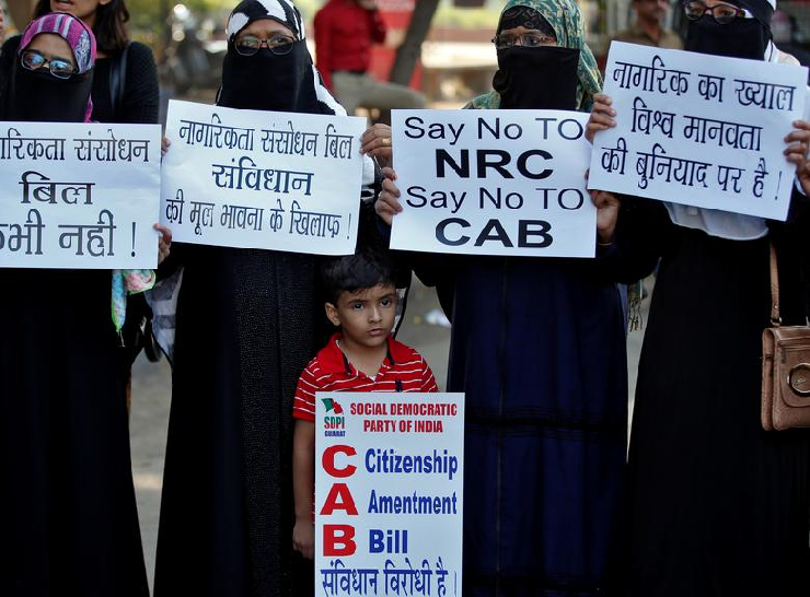 Demonstrators display placards during a protest against the Citizenship Amendment Bill, a bill that seeks to give citizenship to religious minorities persecuted in neighbouring Muslim countries, in Ahmedabad. PHOTO: Reuters
