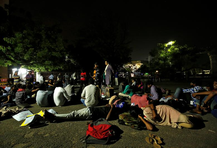 Students sit inside a Madras university compound during a protest against a new citizenship law and to show solidarity with the students of New Delhi's Jamia Millia Islamia University after police entered the university campus on Sunday. PHOTO: Reuters