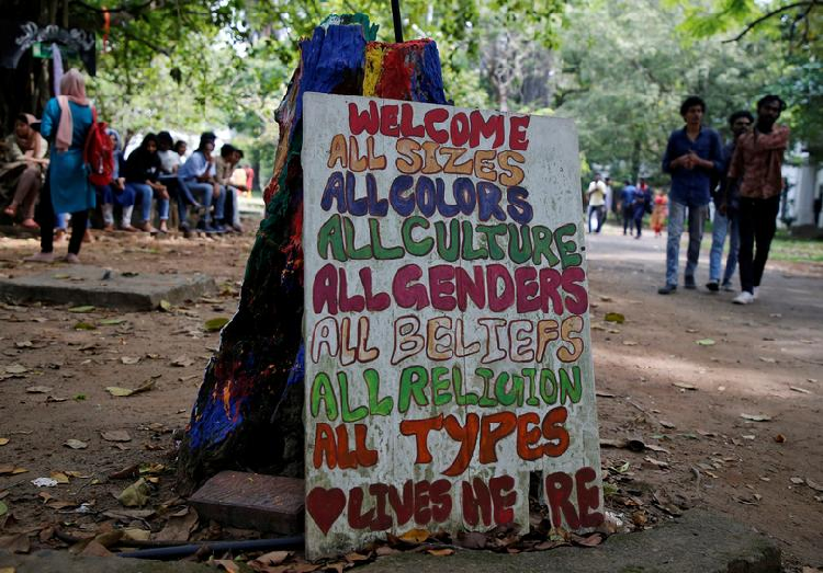 Students gather next to a signboard to attend a protest march against a new citizenship law, inside a college premises in Kochi, India. PHOTO: Reuters