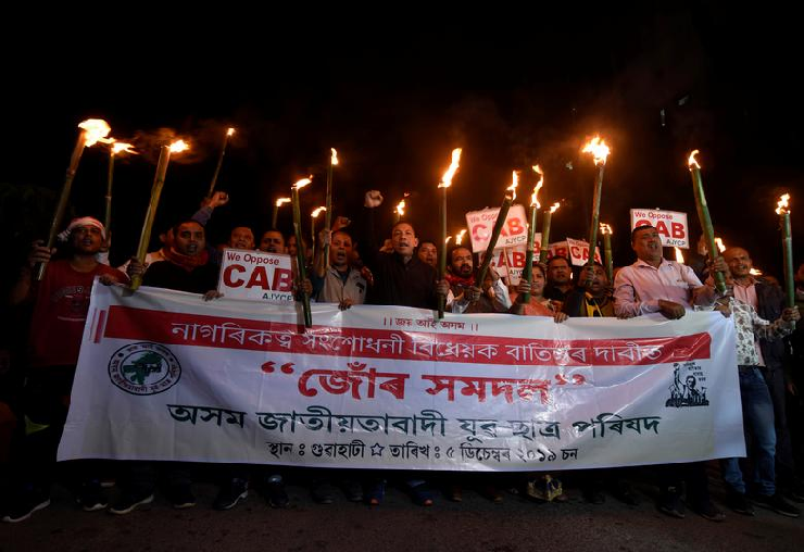 People carrying torches shout slogans during a protest against the Citizenship Amendment Bill. PHOTO: Reuters
