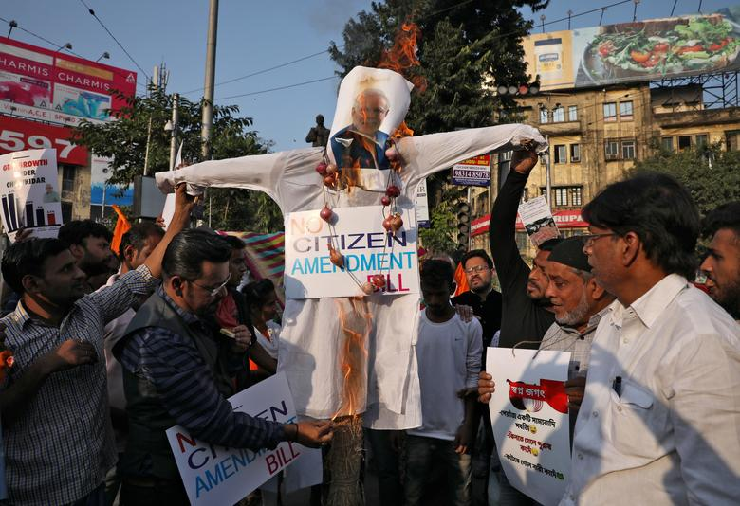 Activists from Indian National Trade Union Congress (INTUC) Seva Dal burn an effigy depicting India's Prime Minister Narendra Modi during a protest against the Citizenship Amendment Bill. PHOTO: Reuters