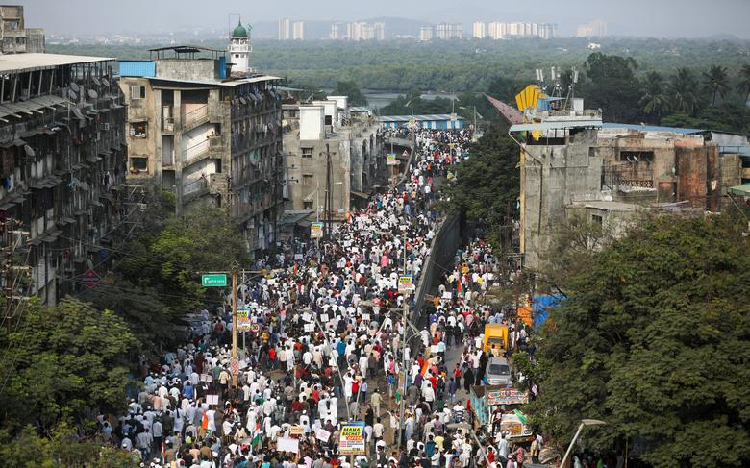 Demonstrators walk during a protest march against a new citizenship law, on the outskirts of Mumbai. PHOTO: Reuters