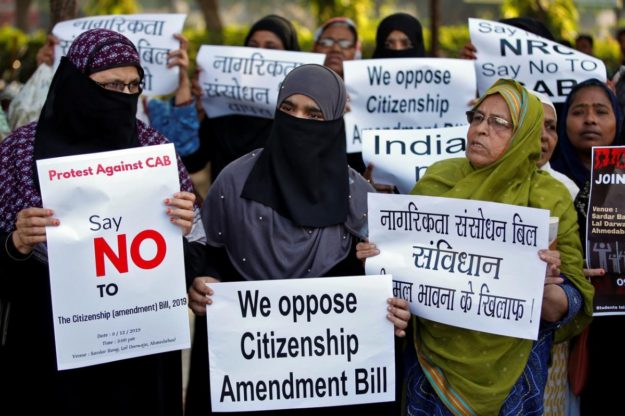 Demonstrators display placards during a protest against the Citizenship Amendment Bill. PHOTO: REUTERS