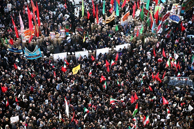 Iranian people attend a funeral procession for Iranian Major-General Qassem Soleimani, head of the elite Quds Force, and Iraqi militia commander Abu Mahdi al-Muhandis, who were killed in an air strike at Baghdad airport, in Tehran, Iran January 6, 2020. PHOTO: REUTERS