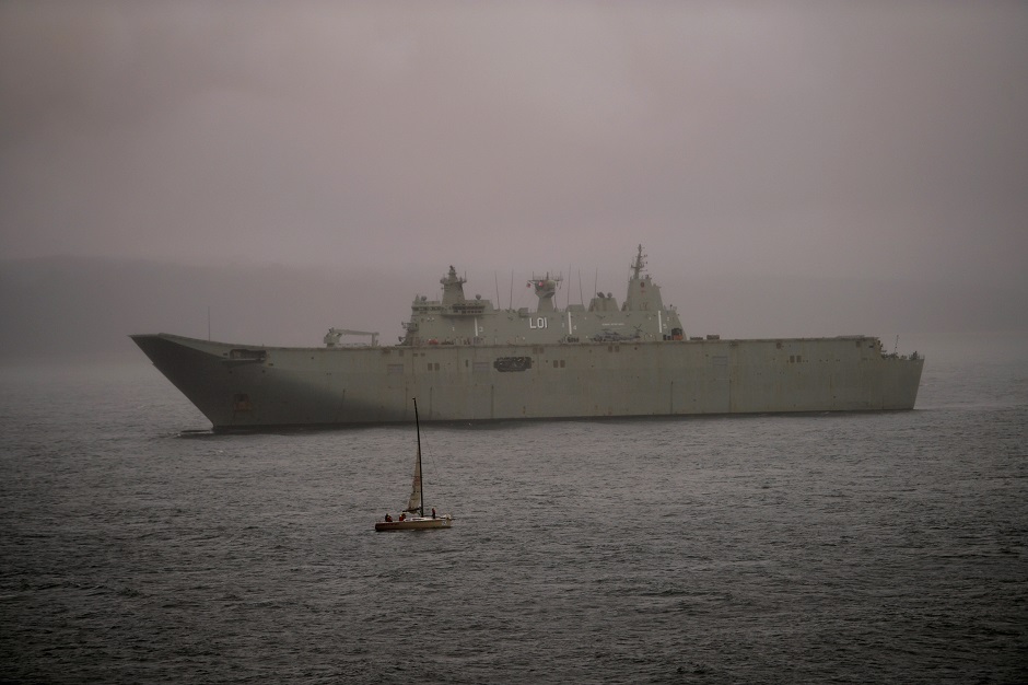  Royal Australian Navy vessel HMAS Adelaide (L01) seen in the misting rain off the coast in Eden, Australia January 6, 2020. PHOTO: REUTERS 