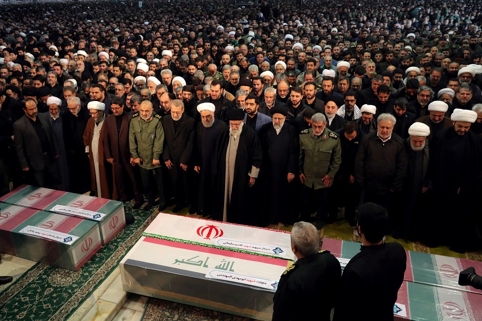 Iran's Supreme Leader Ayatollah Ali Khamenei and Iranian President Hassan Rouhani pray near the coffins of Iranian Major-General Qassem Soleimani, head of the elite Quds Force, and Iraqi militia commander Abu Mahdi al-Muhandis, who were killed in an air strike at Baghdad airport, in Tehran, Iran, January 6, 2020. PHOTO: REUTERS