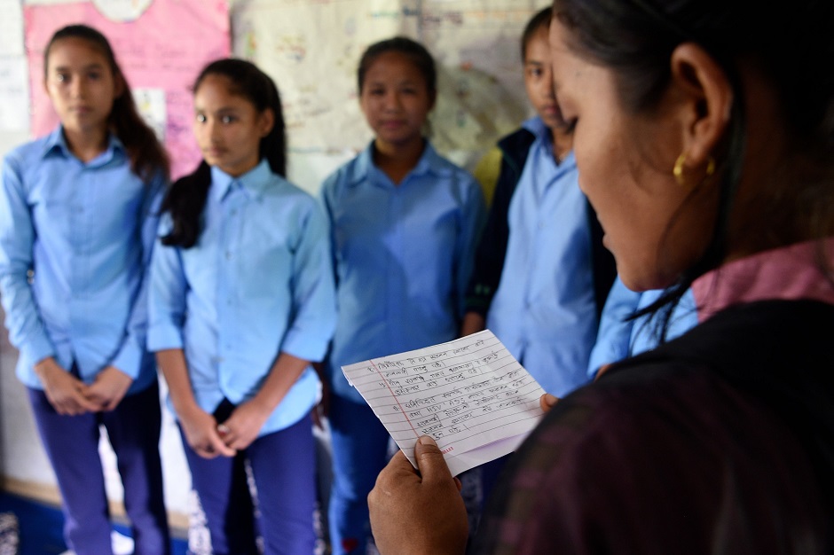  Asha Charti Karki (R), who got married at age 16, mentors young girls on the importance of education in Barahataal in Surkhet District, some 520km west of Kathmandu. PHOTO: AFP