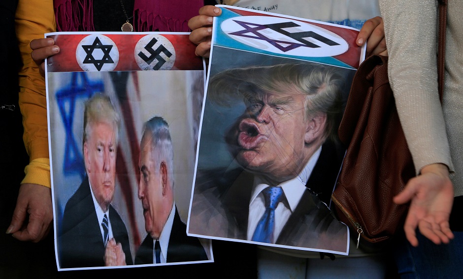 Demonstrators hold posters depicting US President Donald Trump and Israeli Prime Minister Benjamin Netanyahu during a protest against Trump's Middle East peace plan, in Ain al-Hilweh Palestinian refugee camp, near Sidon, Lebanon. PHOTO: REUTERS