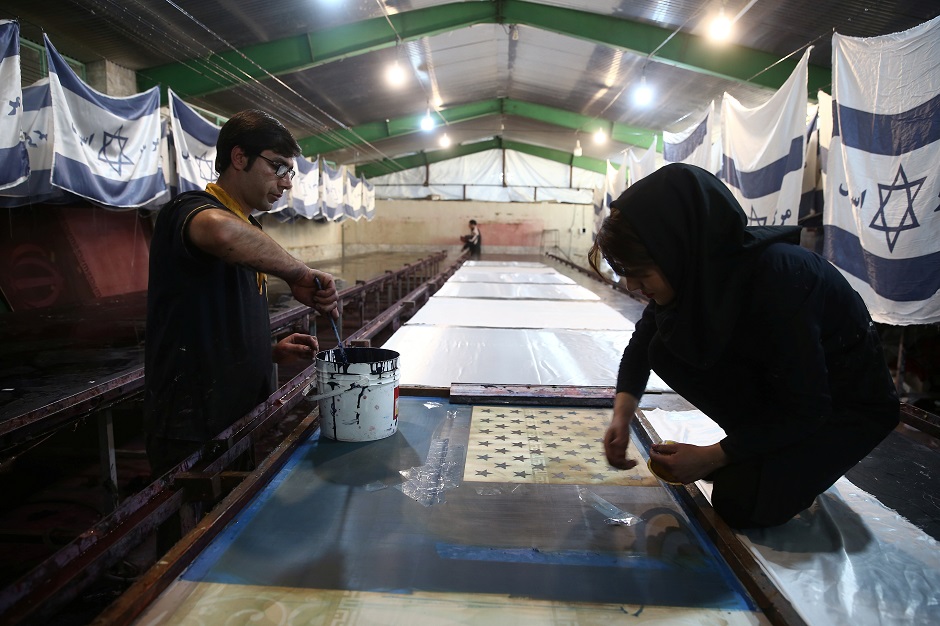 Iranian workers make US flags at a large flag factory which creates them and Israeli flags for Iranian protesters to burn in Khomein City, Iran. PHOTO: REUTERS