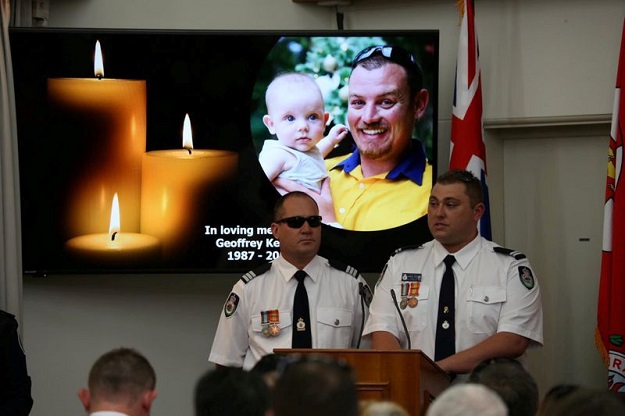 An image of late RFS volunteer Keaton is projected during his funeral in Buxton. PHOTO: AFP